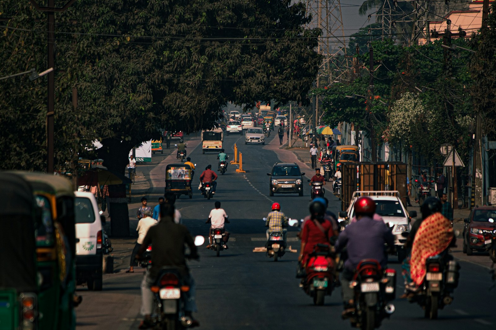 a group of people riding motorcycles down a street