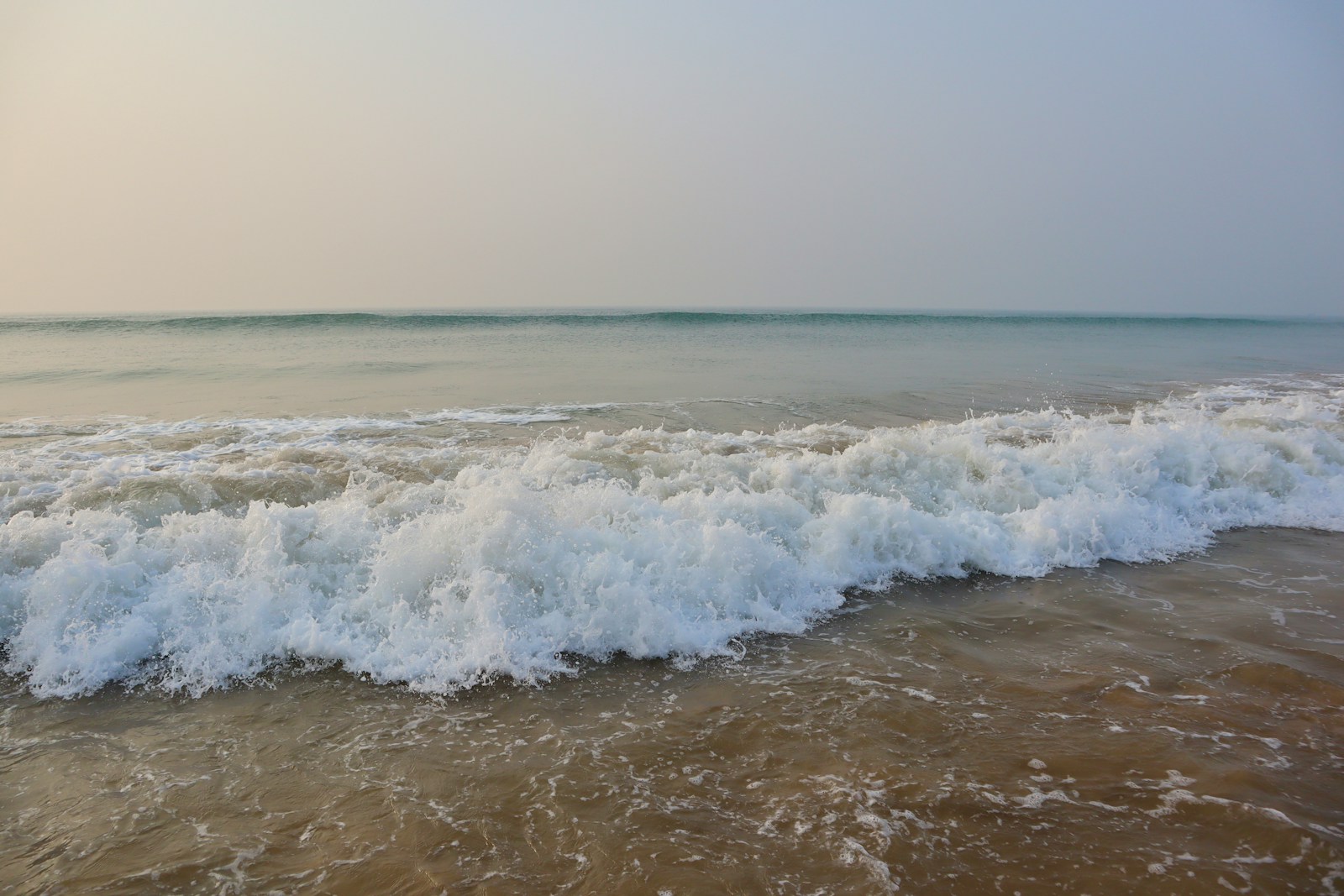 a large body of water with waves coming in to shore