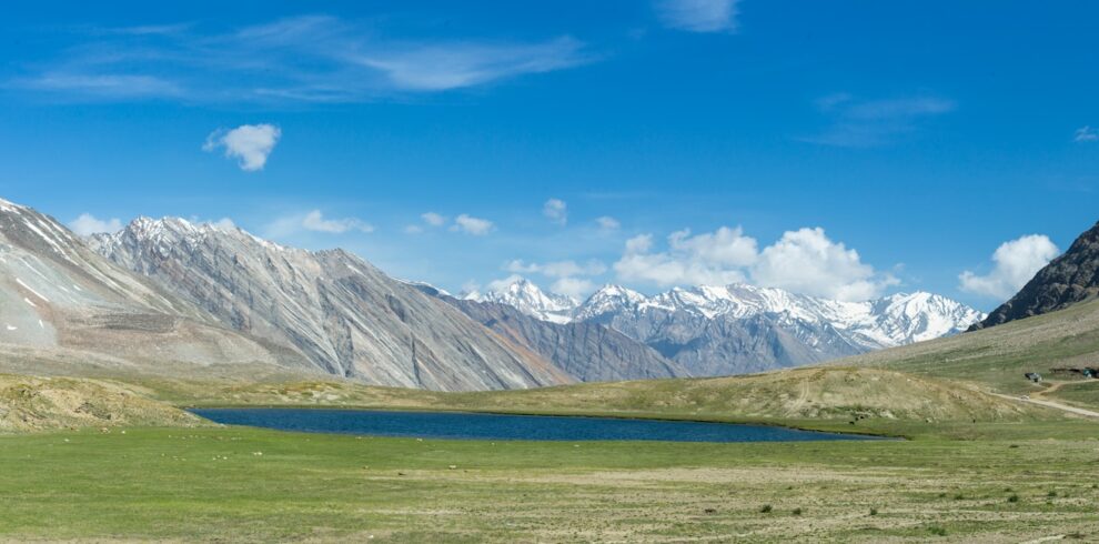 a mountain range with a lake in the foreground