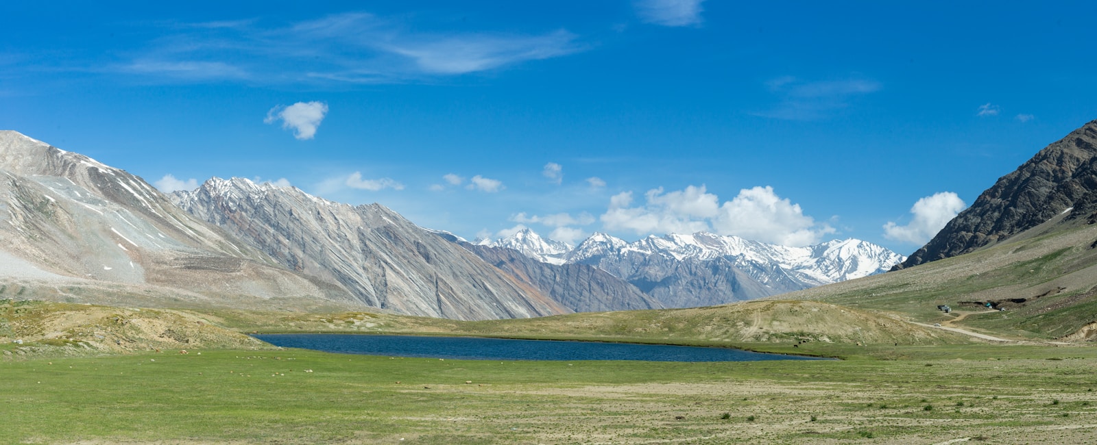 a mountain range with a lake in the foreground