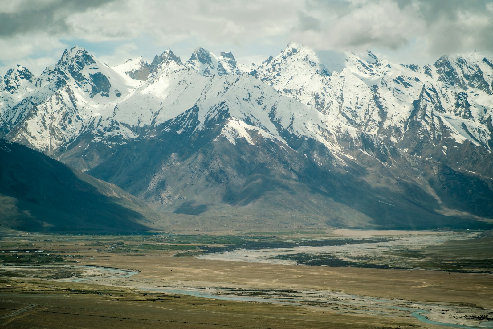 A view of a mountain range with a river in the foreground