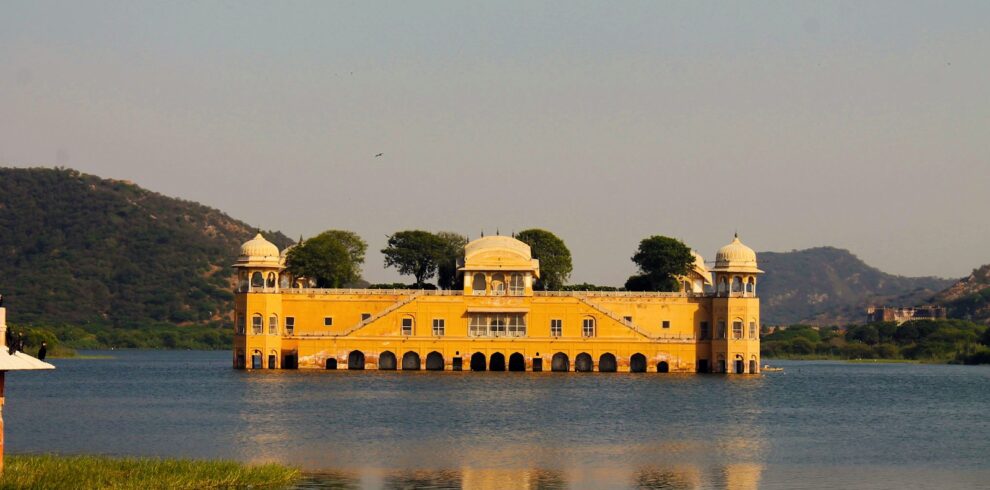 a large yellow building sitting on top of a lake