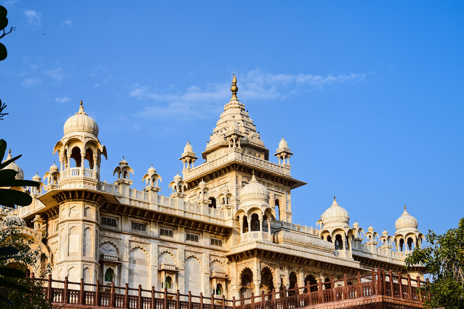 a large white building with two towers and a balcony