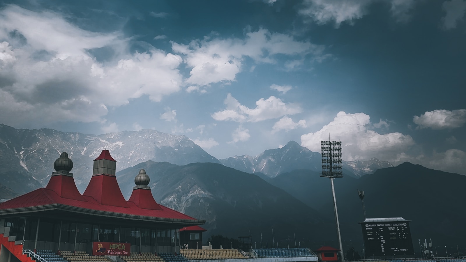 a stadium with mountains in the background