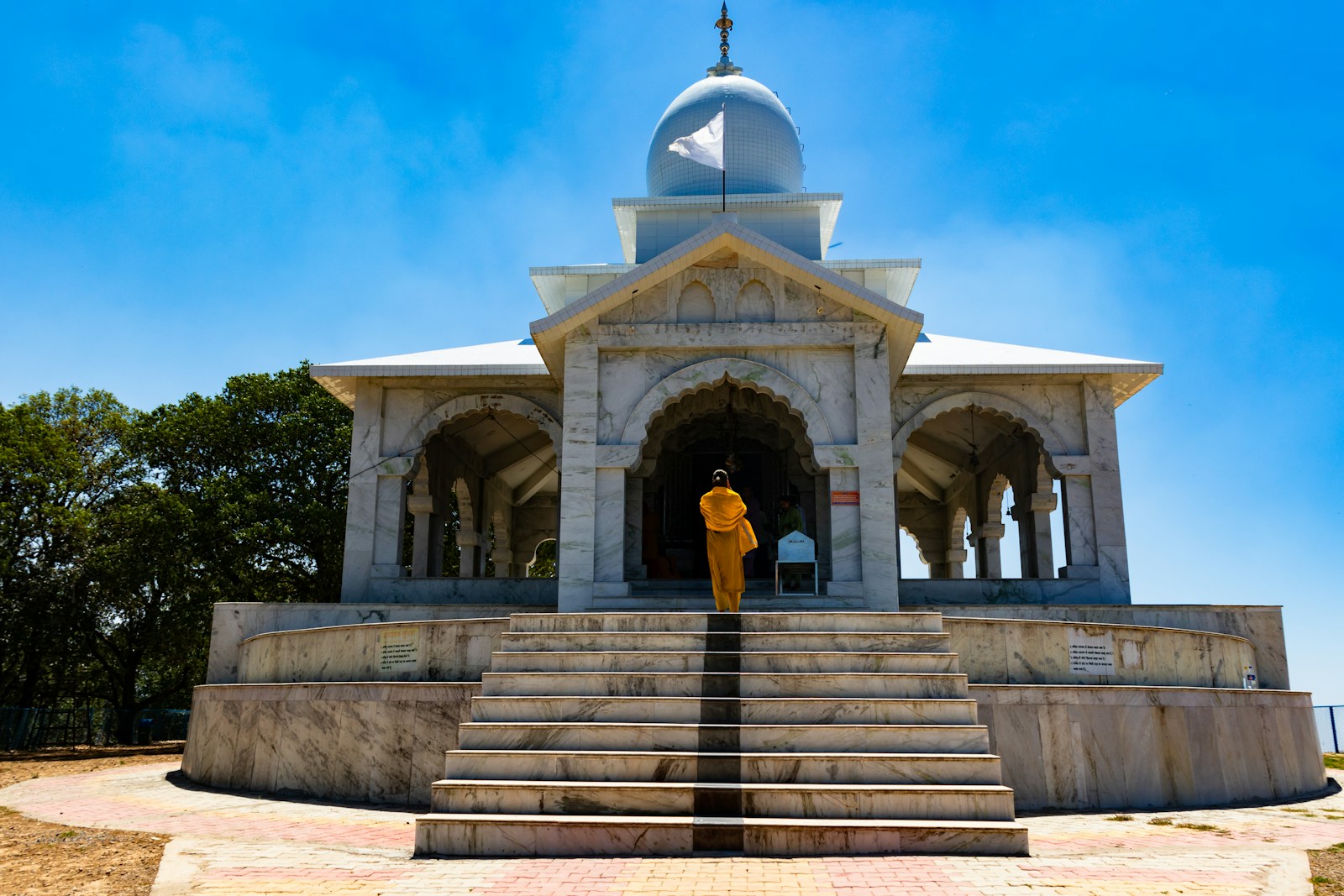 A person standing at the entrance of a building