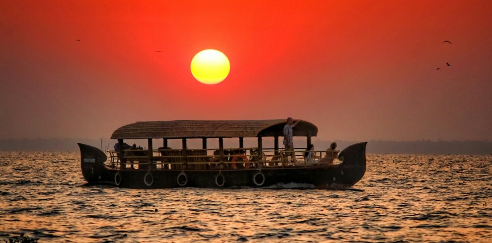 silhouette of boat on sea during sunset