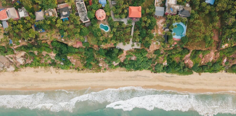 aerial view of houses near body of water during daytime