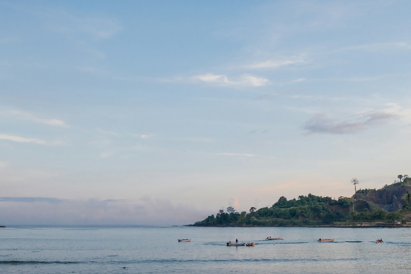 people riding on boat on sea during daytime